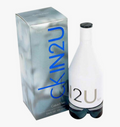 Calvin Klein Skin2U cologne bottle and packaging box on a white background. The bottle is white with a black cap and blue-gray gradient base, next to a metallic silver box with blue 'skin2U' lettering.