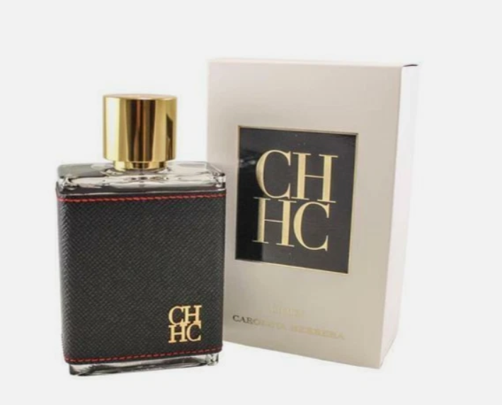 Carolina Herrera CH HC perfume bottle with a textured black leatherette wrap and gold cap, shown next to its cream-colored packaging box with a black CH HC logo.