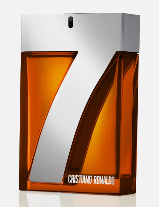 Cristiano Ronaldo CR7 perfume bottle with a large metallic silver number 7 on an amber-orange transparent rectangular bottle, on a light gray background.