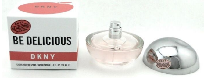 DKNY Be Delicious Eau de Parfum bottle with its silver atomizer cap and retail box on a white background.