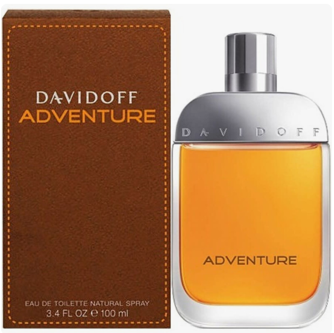 Davidoff Adventure Eau de Toilette bottle with amber liquid next to its brown textured box packaging, on a white background.