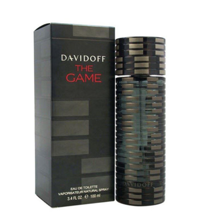 Davidoff The Game Eau de Toilette bottle and packaging box. The cylindrical bottle features a dark metallic striped pattern, standing next to its black box with red and white text.