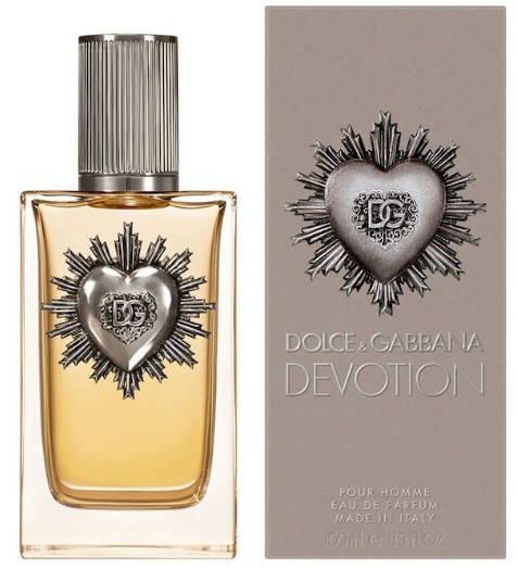 Dolce & Gabbana Devotion Pour Homme Eau de Parfum bottle with amber liquid and a silver heart emblem, shown next to its taupe packaging box.