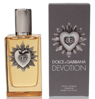 Dolce & Gabbana Devotion Pour Homme perfume bottle with amber liquid and silver heart emblem, shown next to its dark gray packaging box with matching heart design.