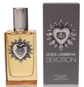 Dolce & Gabbana Devotion Pour Homme perfume bottle with amber liquid and silver heart emblem, shown next to its dark gray packaging box with matching heart design.