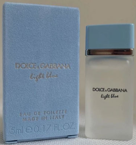 Dolce & Gabbana Light Blue Eau de Toilette bottle and its matching blue textured box, displayed side-by-side against a neutral beige background.