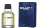 Dolce & Gabbana Pour Homme Eau de Toilette bottle with pale yellow liquid next to its textured navy blue box, on a white background.