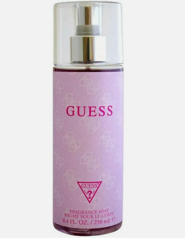 A bottle of GUESS Fragrance Mist in a light purple/lavender color with a silver pump and clear cap, on a plain white background.