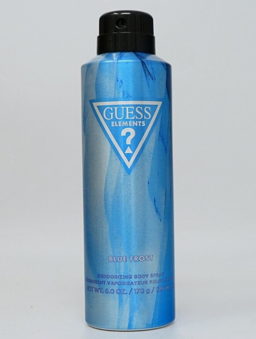 A can of Guess Elements deodorizing body spray in the Blue Frost scent, featuring a metallic blue and light blue marbled design with a black cap.