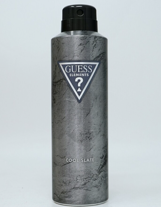 A Guess Elements Cool Slate deodorant spray can with a textured gray and black marble pattern, featuring the Guess Elements logo on the front, set against a plain light gray background.