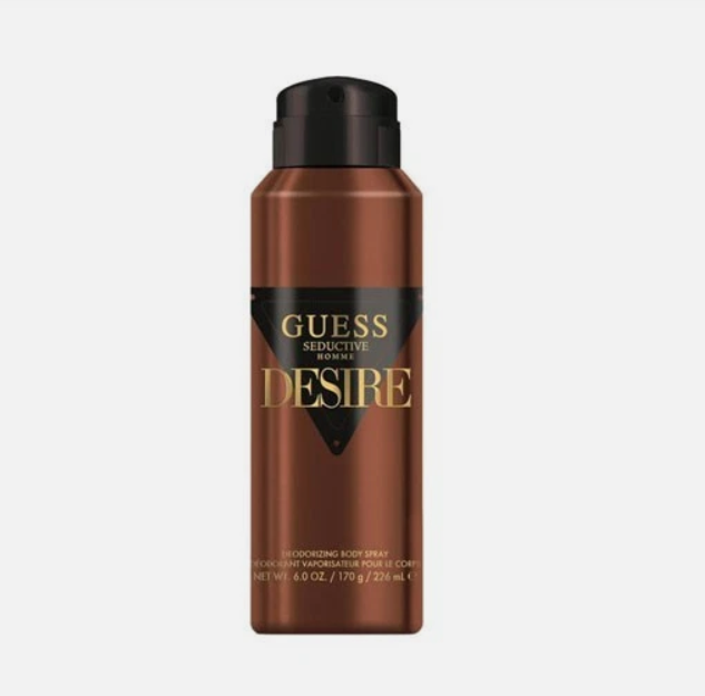 A bottle of Guess Seductive Desire Body Spray, featuring a metallic bronze-brown bottle with a black cap and a black label with gold lettering, set against a plain light gray background.
