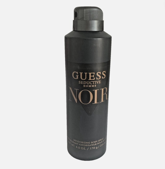 A matte black can of Guess Seductive Hommes Noir body spray, featuring gold lettering on a light gray background.