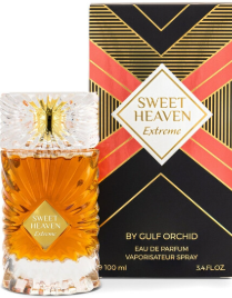 Sweet Heaven Extreme Eau de Parfum bottle and its packaging box by Gulf Orchid. The clear glass bottle shows the amber-colored fragrance liquid inside, with a gold cap.