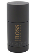 Hugo Boss The Scent deodorant stick in a matte black cylindrical container with gold lettering, shown against a plain white background.