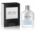 Jimmy Choo Urban Hero Eau de Parfum bottle with a silver cap next to its black and white patterned retail box, on a white reflective background.