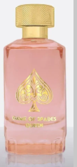 A bottle of S.P. Games London perfume with a pink liquid, a gold cap, and a gold spade logo on the front.