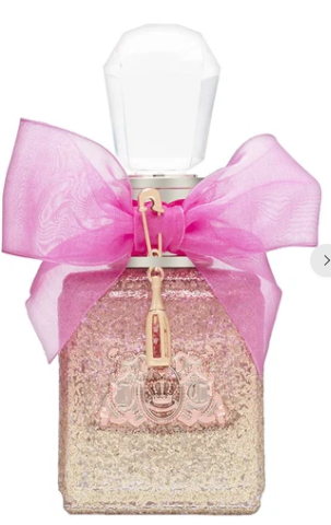 A square glass perfume bottle filled with shimmering pink glitter, topped with a faceted white cap and decorated with a large pink organza bow and a gold-tone charm, shown on a white background.