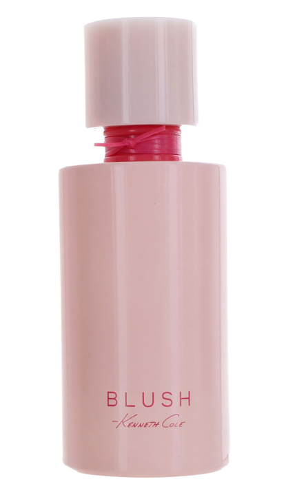 A pink cylindrical perfume bottle with a matching cap, featuring the text 'BLUSH' and 'Kenneth Cole' printed on the front, set against a plain white background.