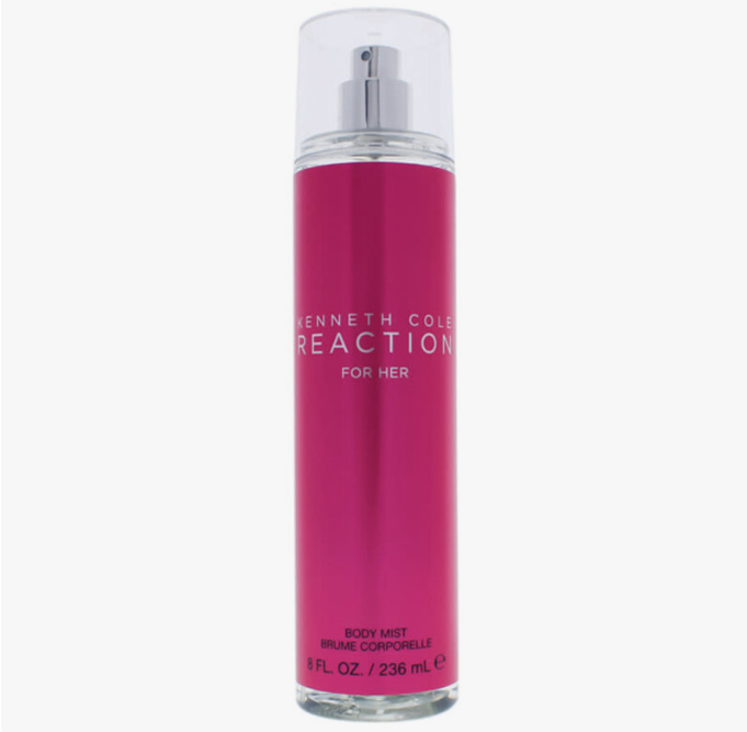 Kenneth Cole Reaction 'For Her' body mist in a clear cylindrical spray bottle with a metallic magenta pink label and a silver pump dispenser, shown against a plain white background.