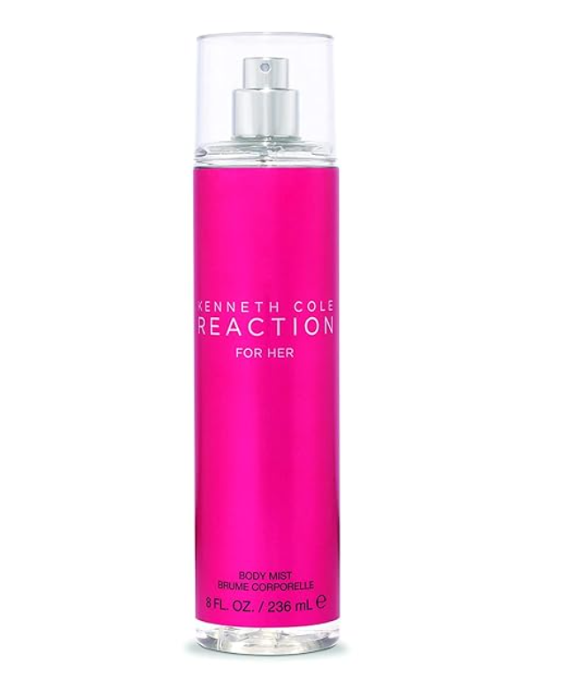 A tall cylindrical spray bottle of Kenneth Cole Reaction For Her body mist, featuring a vibrant hot pink label with white text and a clear cap, set against a plain white background.
