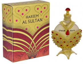 Harem Al Sultan perfume bottle and its decorative packaging box. The bottle is ornate gold with red jewel-like accents and a red cap, while the box features a matching gold and red patterned design with the text 'HAREEM AL SULTAN'.