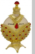 A decorative gold-toned bottle with a cream-colored neck, red gemstone accents, and Arabic calligraphy on the front, shown against a plain white background.