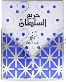 A square decorative box or package with a white top section featuring blue dots and Arabic calligraphy, plus a blue-and-white geometric patterned lower section. The word 'KHADLA' is visible near the center.