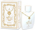 A white perfume bottle with a gold heart pendant necklace displayed alongside its ornate white and gold packaging box.