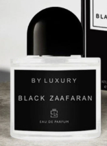 A luxury perfume bottle labeled 'BY LUXURY BLACK ZAAFAARAN' with a black cap and black label, set against a dark background with a blurred branded box behind it.