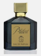 A dark blue glass perfume bottle with a gold cap and a gold label reading 'Bleached Oud 500' and 'Eau de Parfum'.