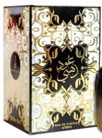 A boxed fragrance product with ornate gold Arabic calligraphy and filigree on a cream and black box. The front shows the text 'EAU DE PARFUM' and 'MADDAH', and a bottle is partially visible at the right edge.