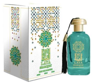 Laya Sharqay perfume bottle and its decorative packaging box. The bottle is a translucent teal green with a gold cap and tassel, and the box is white with gold and green geometric patterns.