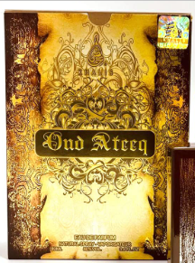 A square decorative box or package with ornate gold and brown filigree artwork and the text 'Bad Rterq' across the front, photographed against a dark background.