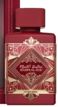A red rectangular perfume bottle with a matching cap and a decorative geometric label featuring gold lines and Arabic text, shown against a dark background.