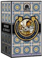 A boxed deck of playing cards with ornate blue and gold tile-style artwork, a large gold horseshoe emblem on the front, and the title 'Spina de Oro' visible on the packaging.