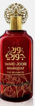 A red glass perfume bottle with a gold ornate cap and gold Arabic lettering on the front, labeled Ward Joori Sharqiyat Eau de Parfum.