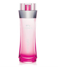 Lacoste Touch of Pink perfume bottle, featuring a translucent pink body that gradients to a vibrant magenta at the base, with a metallic silver collar and a matching pink spray nozzle under a silver cap, set against a plain white background.