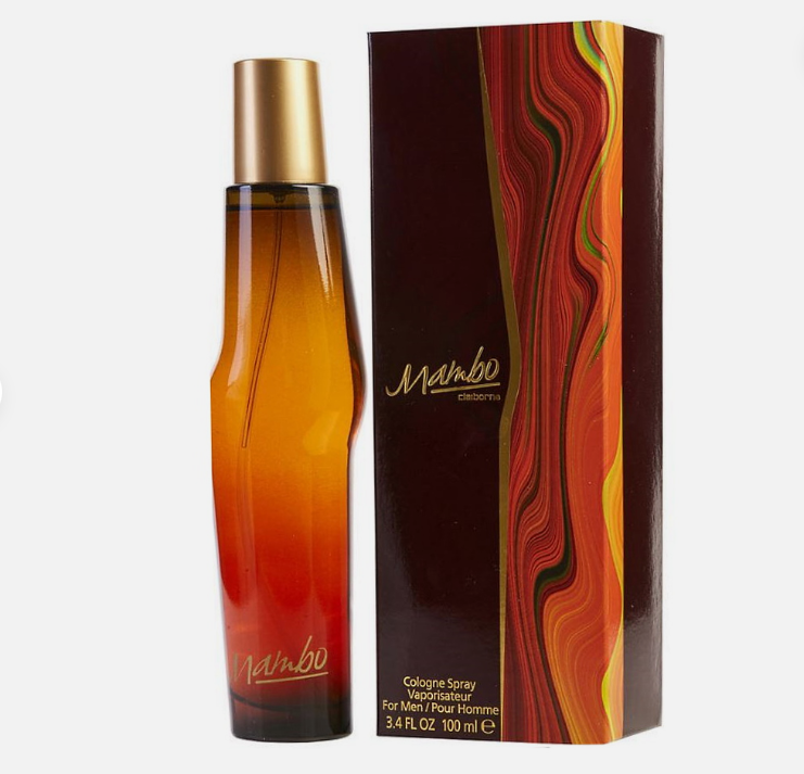 A bottle of Mambo cologne with a gold cap next to its retail box, both featuring a warm gradient design from amber to red and orange on a light gray background.