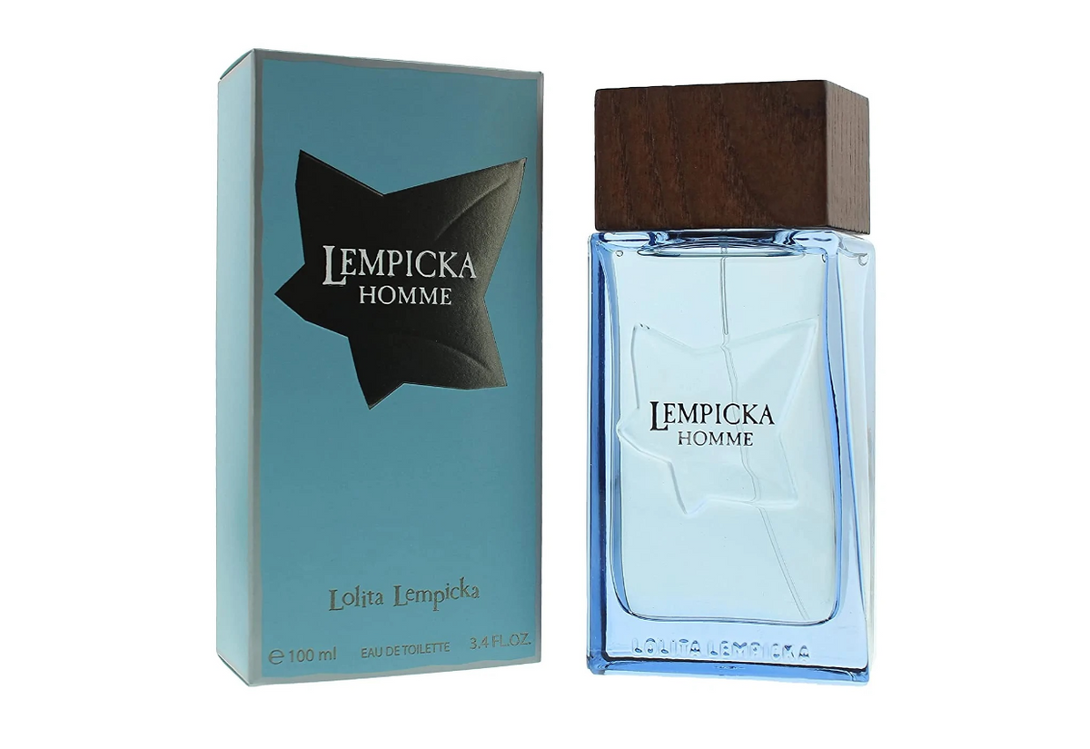 Lolita Lempicka Homme Eau de Toilette shown with its light blue packaging box and the clear glass perfume bottle featuring a dark wood cap, on a white background.