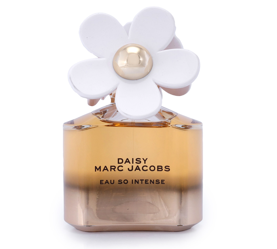 Marc Jacobs Daisy Eau So Intense perfume bottle with a white flower cap and amber-colored liquid, shown on a white background.