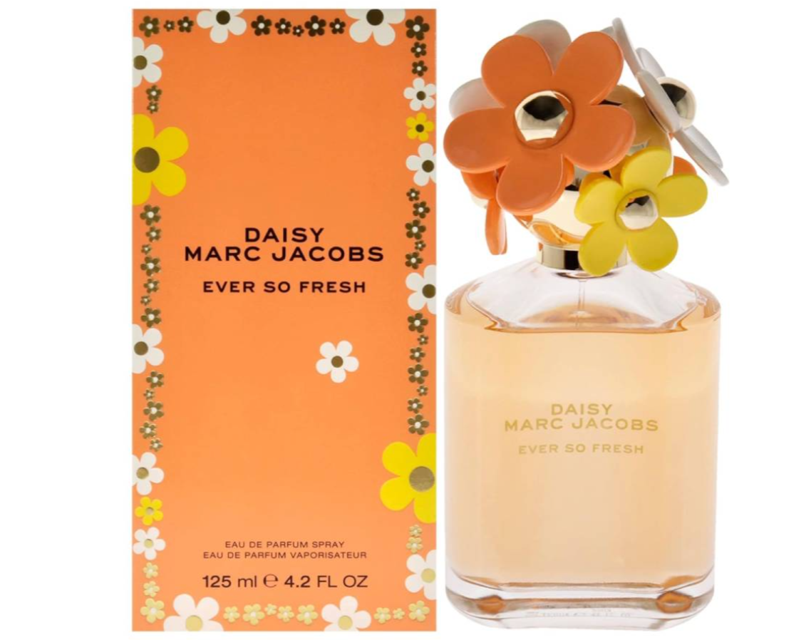 Daisy Marc Jacobs Ever So Fresh Eau de Parfum bottle with its orange floral box packaging, featuring a clear glass bottle with pale yellow liquid and a cap decorated with large orange and yellow flowers.