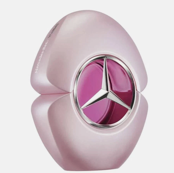 Mercedes-Benz Beauty Venus perfume bottle in a glossy metallic light pink shape, featuring the Mercedes-Benz three-pointed star logo on a magenta-pink circular face with a silver border.