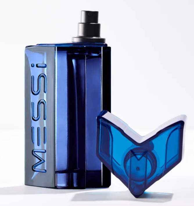 Messi Blue cologne bottle in a translucent deep blue glass with a black spray nozzle, shown next to its matching blue and white cap on a clean white background.