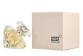 Mont Blanc Lady Eau de Parfum bottle with a faceted clear crystal design containing pale gold liquid, shown next to its cream-colored packaging box with the Mont Blanc Emblem logo.