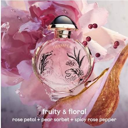 A round glass perfume bottle labeled OLYMPIA, filled with pale pink liquid and decorated with botanical line drawings, set against large pink flowers. Text at the bottom reads 'fruity & floral' and 'rose petal + pear sorbet + spicy rose pepper'.