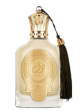 A clear glass perfume bottle with ornate gold detailing, a gold cap, and a black tassel, shown on a plain white background.