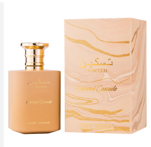 Taskeen Caramel Cascade perfume bottle in a warm peach-beige shade with a shiny gold cap, shown next to its matching decorative packaging box featuring gold marbled lines on a white background.