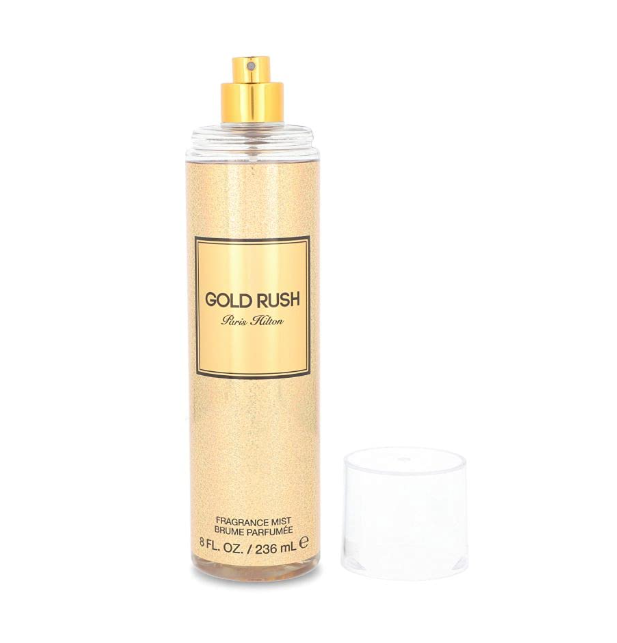A bottle of Paris Hilton 'Gold Rush' fragrance mist with a gold cap and a clear cap placed beside it on a white background.