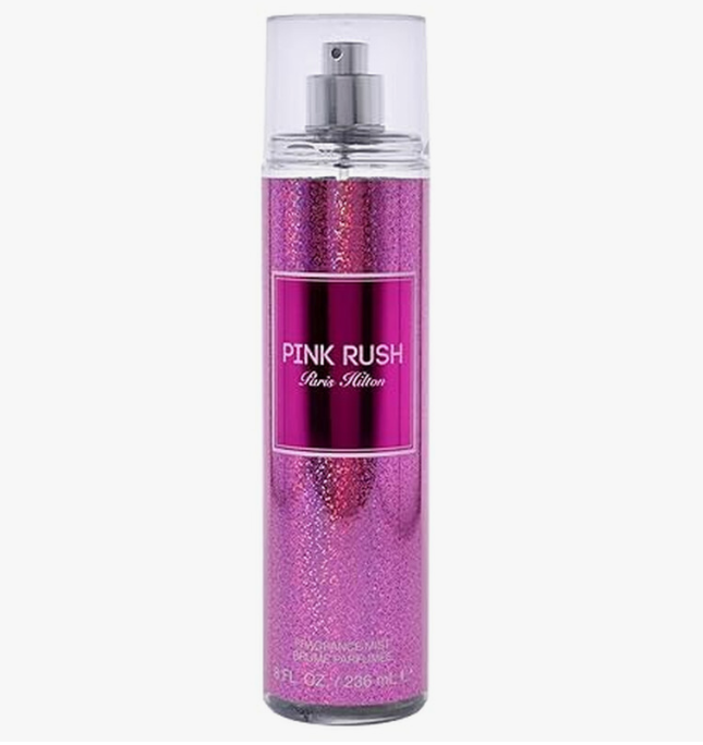 A 5 oz clear spray bottle of PINK RUSH Paris Hilton fragrance with a glittery pink body and a silver pump, shown on a light gray background.