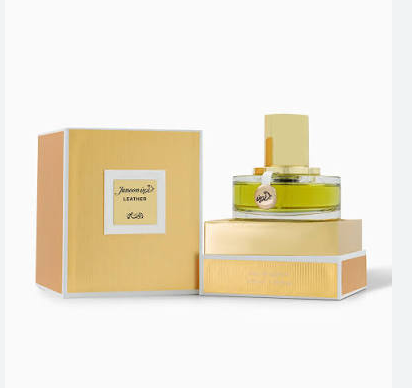 A perfume bottle with pale yellow-green liquid and a gold cap, displayed next to its matching gold and peach packaging box on a clean white background.